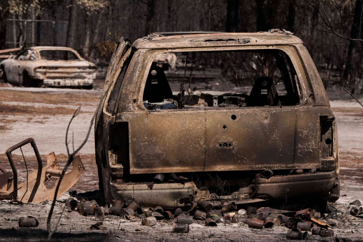 Burned truck amid wildfire destruction — Hurricane Helene debris fueling fires