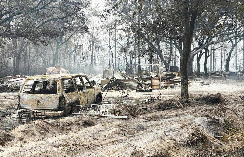 Burned vehicles and destroyed property in Brantley County wildfire aftermath